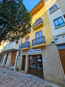 a building with a store in front of it at Hostal JP y Apartamentos in Sangüesa