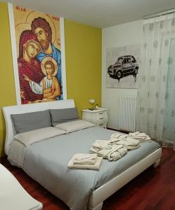 1 dormitorio con 1 cama con una pintura en la pared en Suite Gravina + box auto privato, en Gravina in Puglia