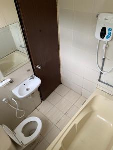 a bathroom with a toilet and a sink and a tub at KB MYPLACE in Kota Bharu