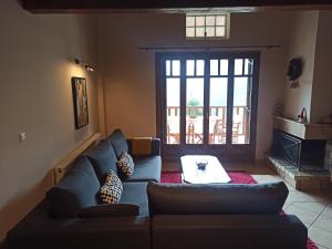a living room with a couch and a table at Helmos Mountain Retreat in Zarouchla +61 photos