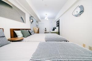 Krevet ili kreveti u jedinici u okviru objekta D91新宿最中心 東新宿站5分-Shinjuku center 5 mins to Station, Max 4P 直达新宿 涉谷 表参道 池袋 上野 代代木 银座 原宿