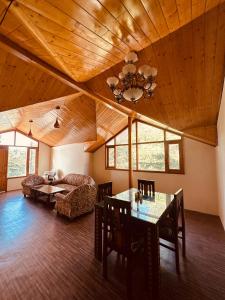 a living room with a table and a couch at Divine Hills Mashobra in Shimla