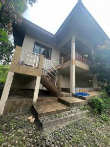 a house with stairs leading up to it at Bungalow vue mer in Amphoe Koksamui