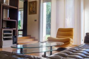 a living room with a couch and a glass table at Luxury villa Bouskoura Pearl in Casablanca