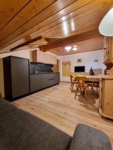 a living room with a table and a dining room at Cesa Elena in Canazei