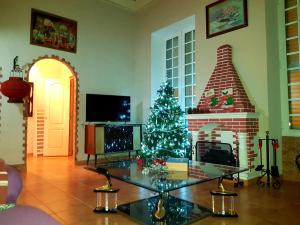 a living room with a christmas tree in front of a fireplace at Casa Familiar CD in Las Palmas de Gran Canaria