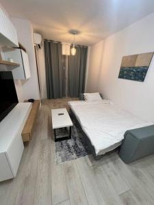a hotel room with two beds and a table at Silver ApartHotel in Bucharest