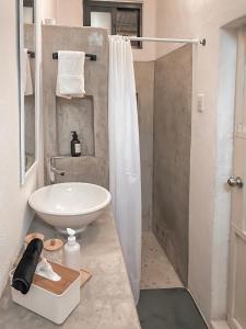 a bathroom with a white sink and a shower at Casa Lucia Beachfront Puerto Morelos in Puerto Morelos