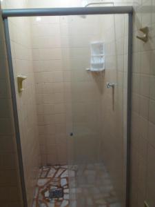 a shower with a glass door in a bathroom at Ninho do pelicano in Fortaleza