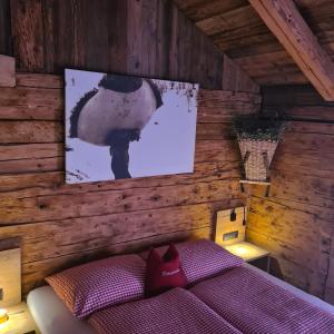 a bedroom with a bed and a picture on the wall at Haus Edelweiss - Ferienhaus in Spiss