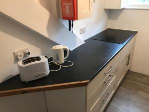 a kitchen counter with a toaster on a counter top at Penzance Seaside studios in Penzance