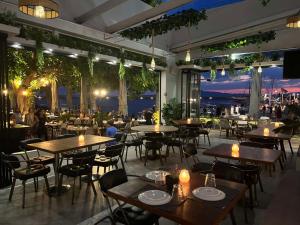 a restaurant with tables and chairs with a view at Panellinion Luxury Rooms in Kalamata