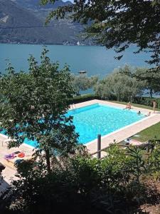 a large swimming pool next to a large body of water at Open space fronte lago in Monte Isola
