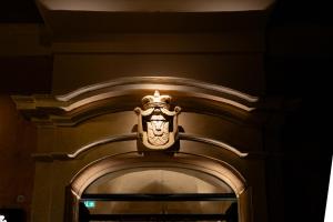 a gold door with a lion on top of it at Lo Stemma Luxury Boutique Hotel in Matera