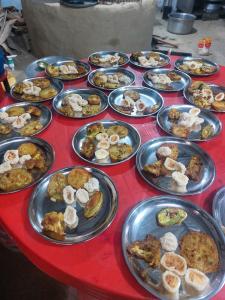 een rode tafel met borden eten erop bij Mithila Thali By Chef Santosh Shah in Janakpur