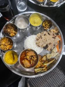 een bord met rijst en verschillende soorten levensmiddelen bij Mithila Thali By Chef Santosh Shah in Janakpur