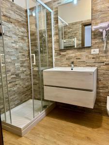 a bathroom with a sink and a shower at Hotel Delle Rose in Mestre