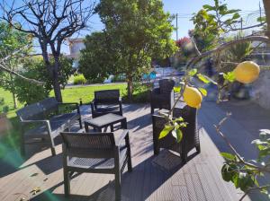 a row of chairs and tables on a patio at Vila com piscina a 5min da praia de Ofir - Esposende in Esposende