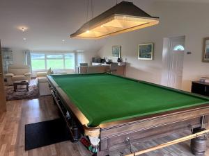 a living room with a pool table in it at Kensington Apartments in Newhouse