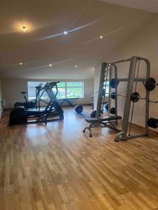 a gym with several treadmills and machines in a room at Kensington Apartments in Newhouse