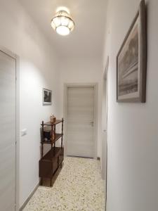 a hallway with white walls and a white door at Domus Lineker in Venafro