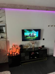 a living room with a tv on a white wall at Habitación LUXURY LOVE in Sant Carles de la Ràpita