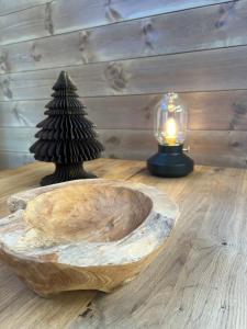 a wooden bowl with a tree on a table with a candle at Rindabotten Panorama in Sogndal