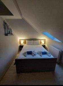 a bedroom with a large bed with two lights on it at Apartman Marija in Nova Varoš