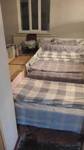 a bed sitting in a room with a mattressvisor at Hostel Praga in Türkistan