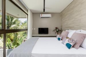 a bedroom with a large bed and a large window at Namorada Atauá in São Miguel dos Milagres +50 photos