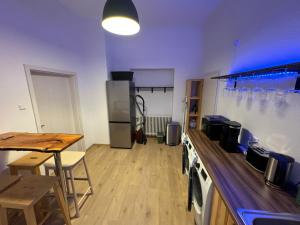 a large room with a kitchen with a counter and a table at 5-room apartment (120 sqm) with 2 bathrooms, 2 kitchens, bar area & balcony directly in the city centre in Karlsruhe