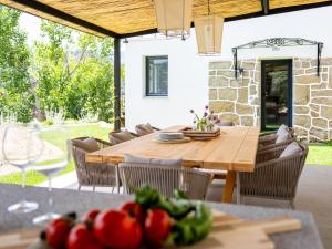 a wooden table and chairs on a patio at Casa junto al Pantano de Burguillo in El Tiemblo