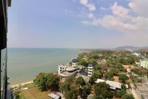 an aerial view of a building next to the ocean at Condo The Zea Shiracha in Ban Bang Phra