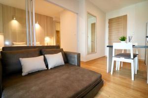 a living room with a couch and a table at Condo The Zea Shiracha in Ban Bang Phra