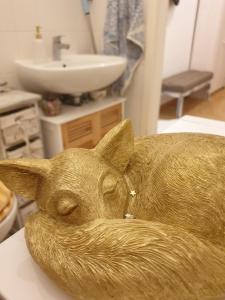 a statue of a dog sitting in a bathroom at Elbe Garden Paradise in Dresden
