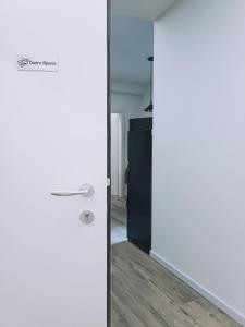 a door in a room with white walls and wood floors at Luxury Apartment Teatro in Bolzano