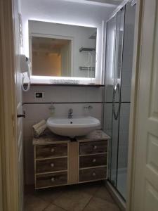 a bathroom with a sink and a mirror at La Casetta di Barzio in Barzio +27 photos