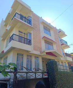 een groot wit gebouw met balkons erop bij Arcadian Home Stay in Shillong