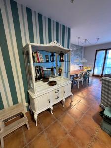 a living room with a white cabinet and a table at Saldes Pedraforca in Saldés