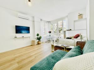 a white living room with a couch and a table at Luxury loft with in the centre in Torremolinos