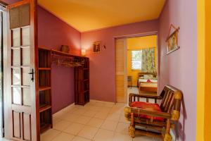 a hallway with a room with purple walls at Kaz Zen in Sainte-Anne