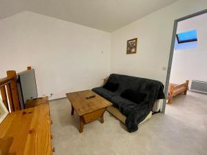 a living room with a couch and a table at Appartement duplex T2 2 à 5 pers in Villard-de-Lans
