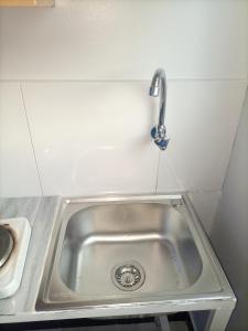 a kitchen sink with a faucet above it at Pearl Motel Buloba in Buloba