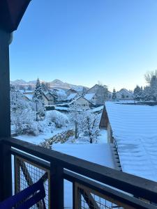 a view of a snow covered yard from a balcony at Appartement duplex T2 2 à 5 pers in Villard-de-Lans