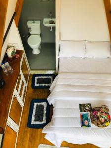 a small bedroom with a bed and a toilet at The WE2 "Wildwood Elegance Escape" in Induruwa