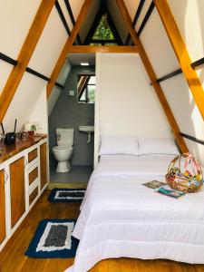 a bedroom with a white bed in a attic at The WE2 "Wildwood Elegance Escape" in Induruwa