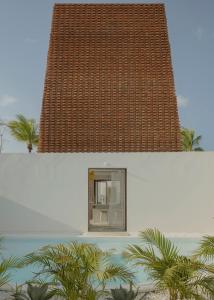 ein weißes Gebäude mit einem Fenster und einem Dach in der Unterkunft Casa Attico - Design Beach House in Touros