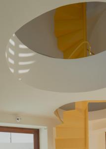 a spiral staircase in a house with a white ceiling at Casa Attico - Design Beach House in Touros