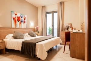 Postel nebo postele na pokoji v ubytování Tuscasì Aparthotel