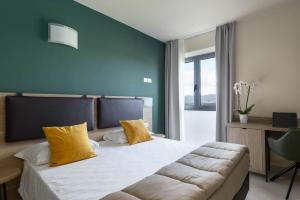 Postel nebo postele na pokoji v ubytování Tuscasì Aparthotel